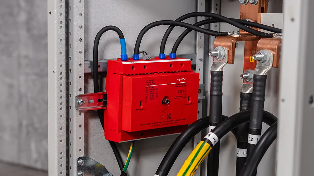 A red box with multiple wires connected to it, showcasing an electronic component setup.