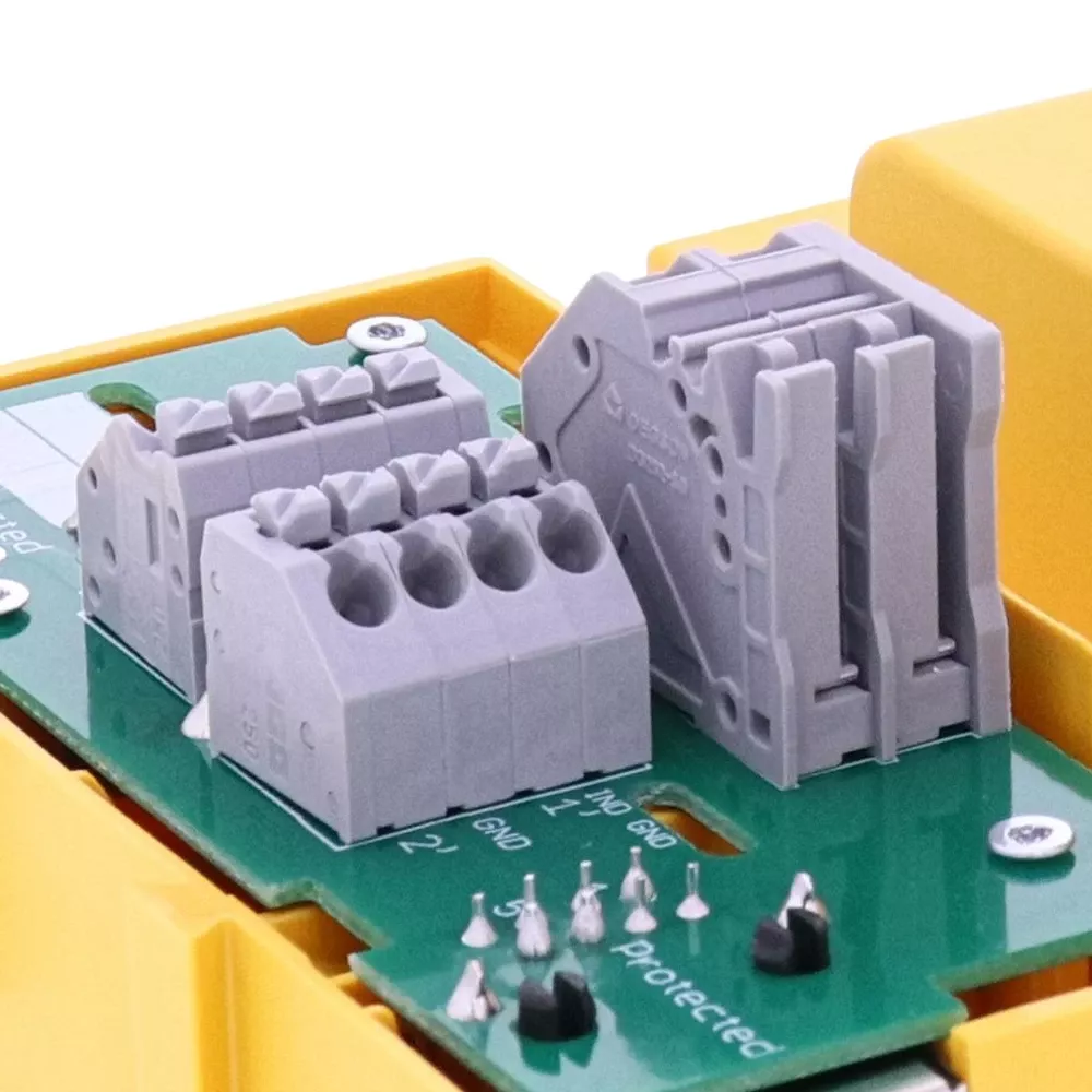 Close-up of terminal blocks and connectors mounted on a green circuit board inside a DEHNbox.